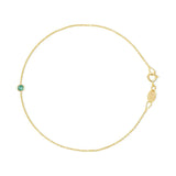 A yellow gold Birthstone Bracelet with a cable chain and an emerald birthstone on a white background. 