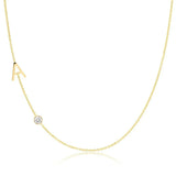 Gold necklace with a small diamond pendant on a white background