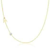 Gold necklace with a small diamond pendant on a white background