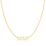 A NANA Necklace in yellow gold on a bead chain on a white background.