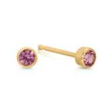 A pair of Birthstone Studs - Pink Tourmaline (October) in yellow gold on a white background.