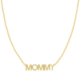 A Pavé MOMMY Necklace in yellow gold on a bead chain on a white background. 