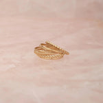 Delicate Trio Stacking Rings on a light pink marble background. 