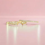 A Pavé Diamond Ring and Open Diamond Ring on a light pink background.
