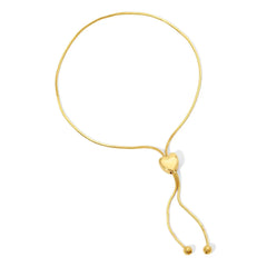 The Slide Heart Bracelet in yellow gold on a white background. 