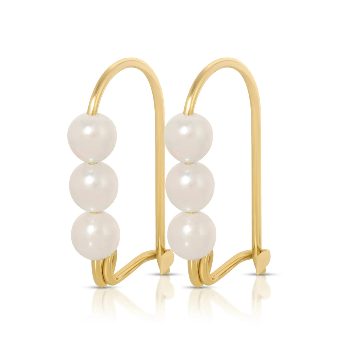 A pair of Tres Pearl Earrings on a white background. 