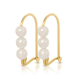 A pair of Tres Pearl Earrings on a white background. 