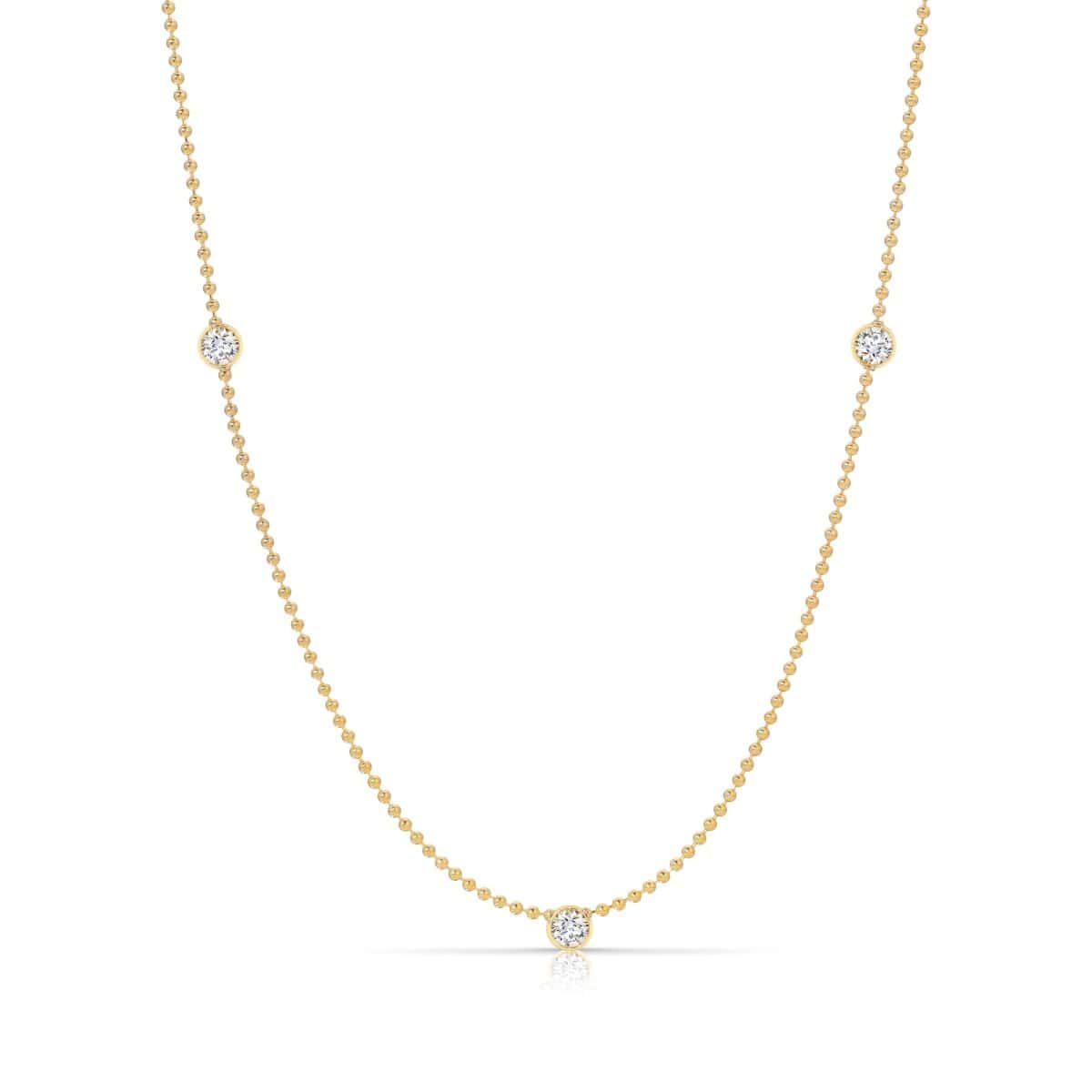 Triple Diamond Layering Necklace in yellow gold on a white background. 