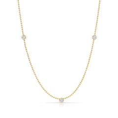Triple Diamond Layering Necklace in yellow gold on a white background. 