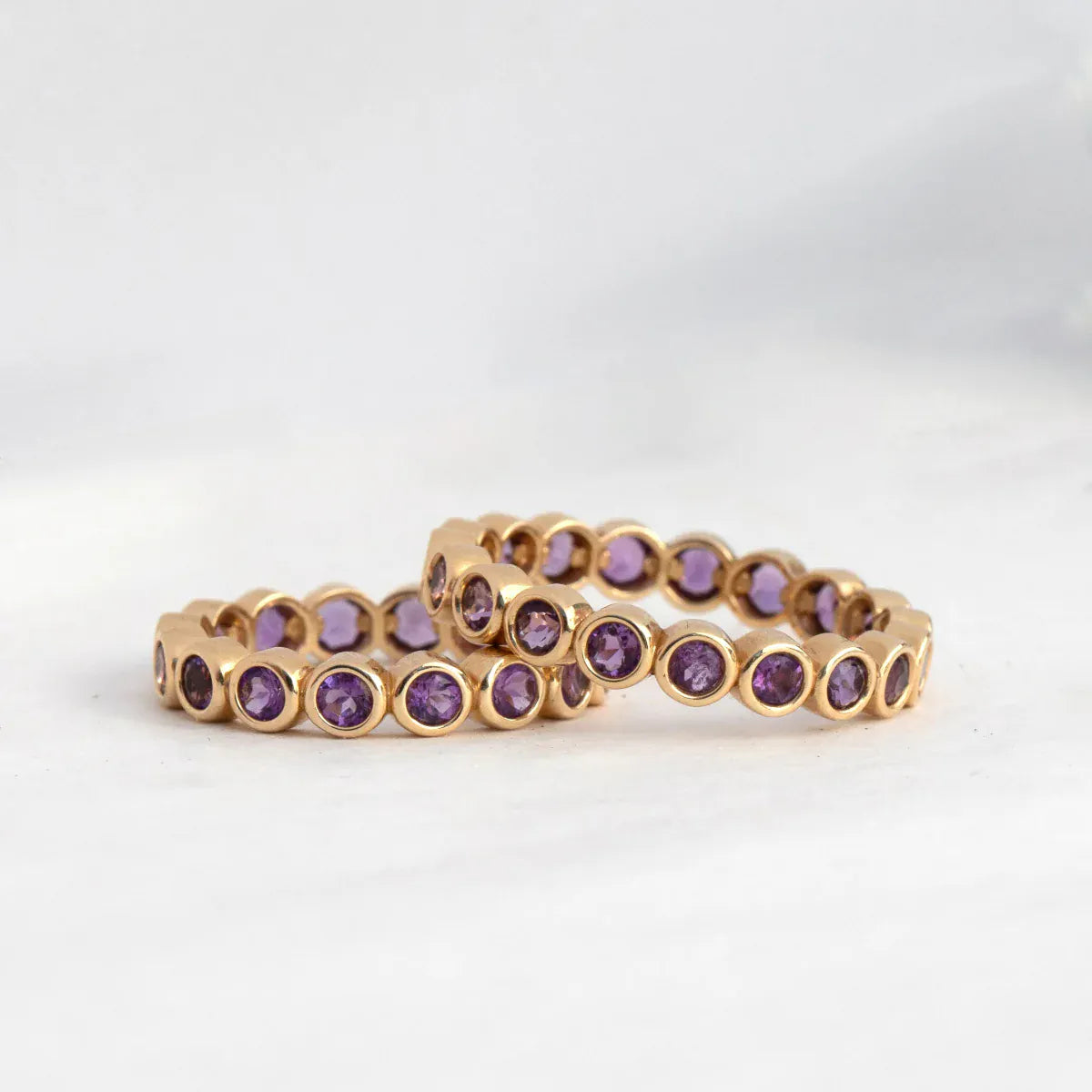 Two The Violet Bouquet Rings against a light grey background. 