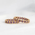 Two The Violet Bouquet Rings against a light grey background. 