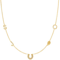 Gold necklace with horseshoe and circular pendant on a white background