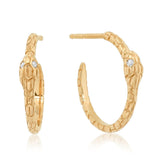 A pair of 14k gold hoop earrings with an etched snakeskin pattern and two diamond eyes.