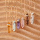 assorted crystal pendants with diamonds on a wood background