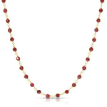Necklace with red beads and gold chain on a white background