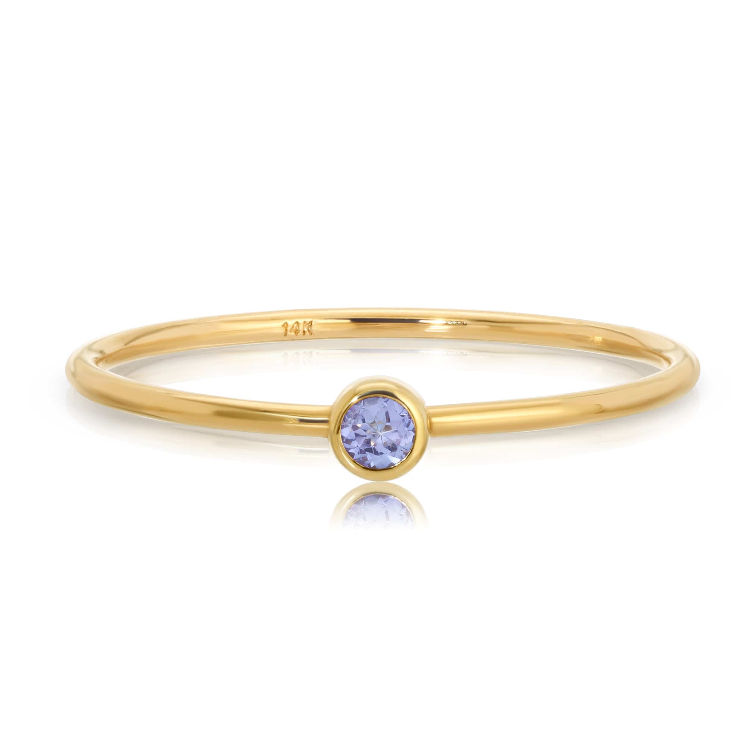 Gold ring with a purple gemstone on a white background