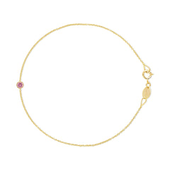 Gold bracelet with a pink gemstone on a white background