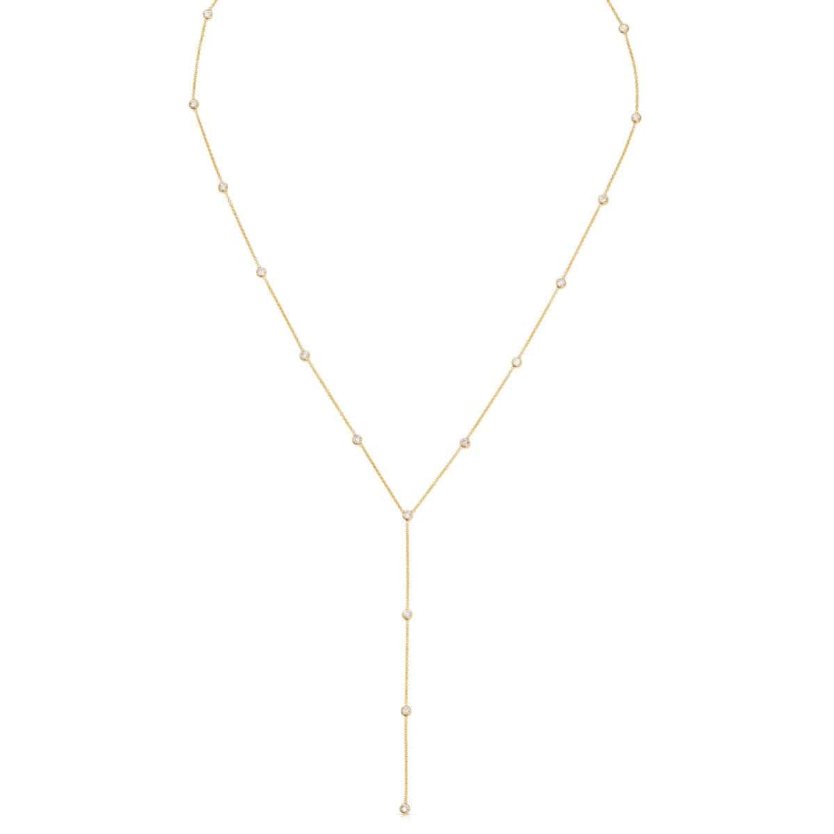 A gold Y-shaped lariat necklace with multiple small diamonds along the chain, displayed against a white background.