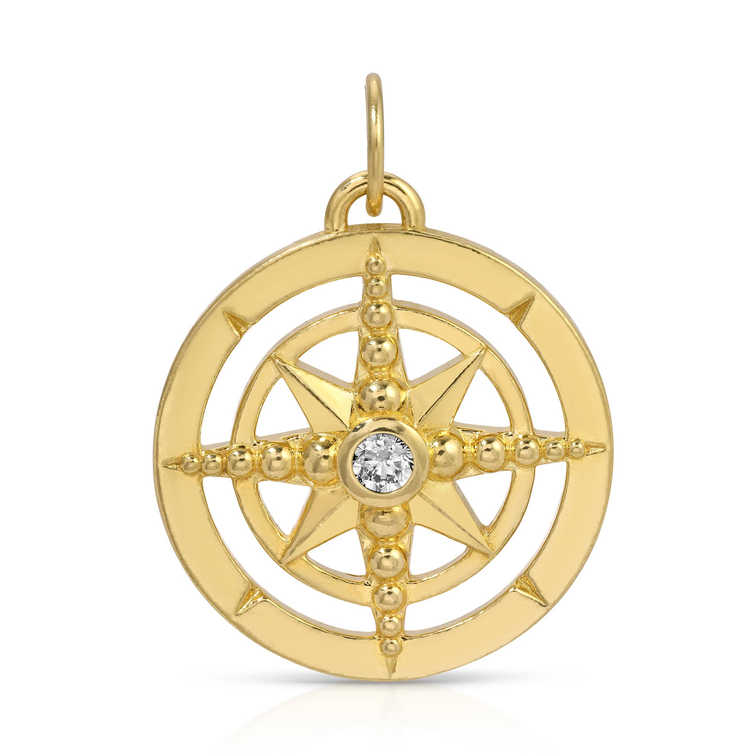Gold compass pendant with a diamond on a white background