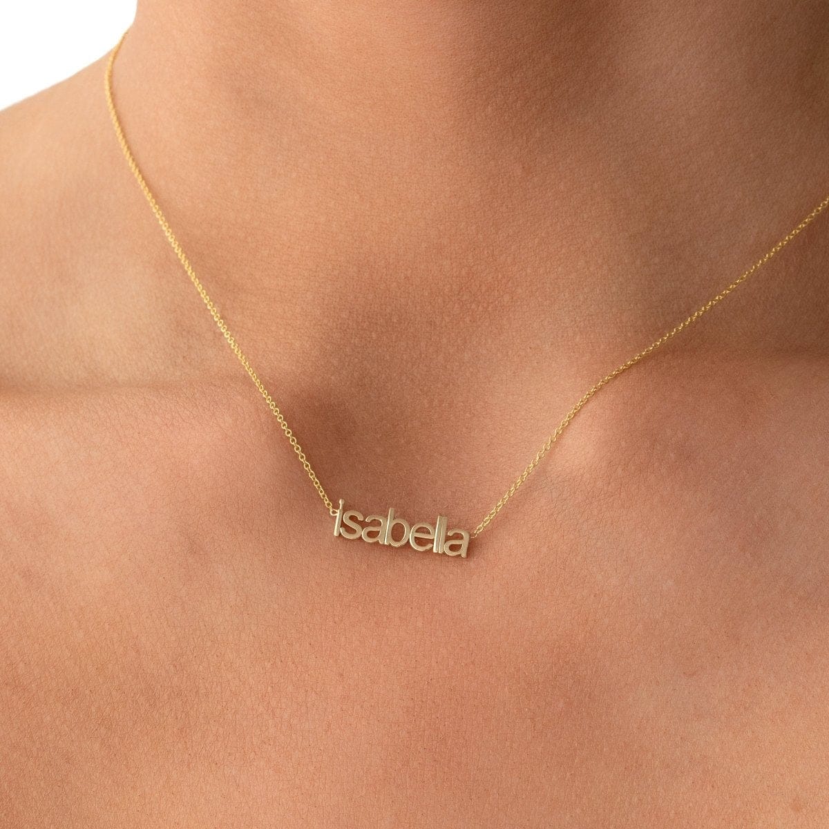 petite nameplate necklace in lowercase letters 'isabella' on gold chain