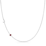 Silver necklace with a small ruby on a white background