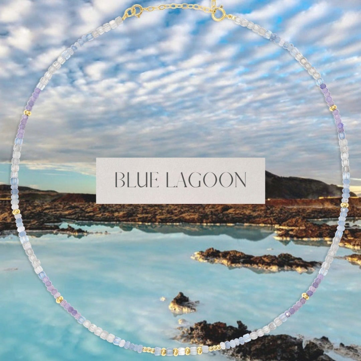 An Endless Summer Necklace - Blue Lagoon over a scenic view of a lake and mountains, with the words "Blue Lagoon" in the centre. 