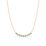 A Birthstone Arc Layering Necklace – Rose Gold in Emerald – May on a white background.