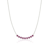 A Birthstone Arc Layering Necklace – White Gold in Ruby – July on a white background.