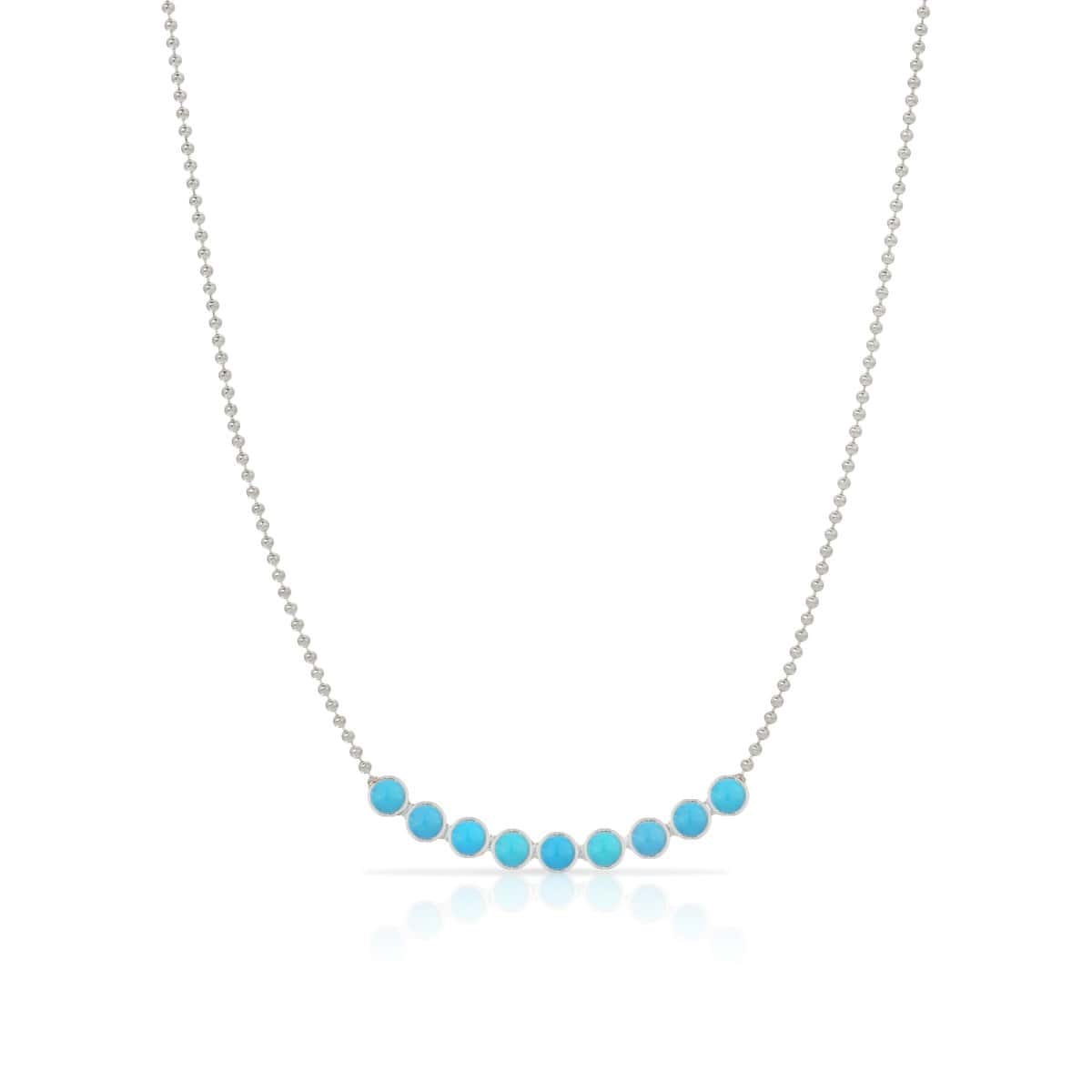 A Birthstone Arc Layering Necklace – White Gold in Turquoise – December on a white background.