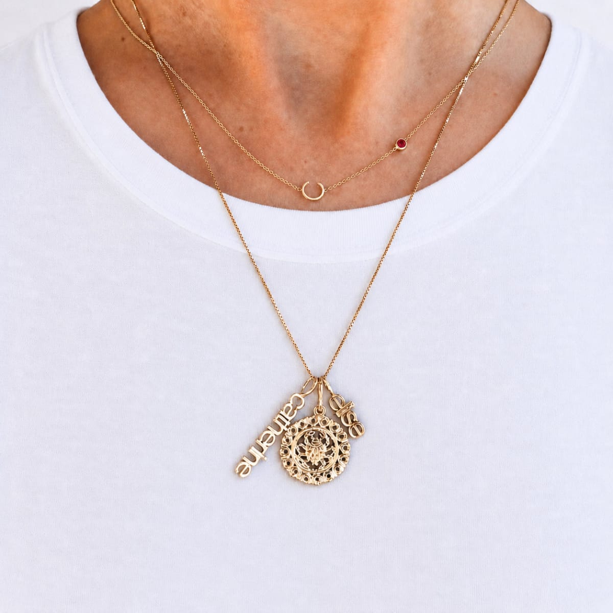 Gold necklace with a pendant on a white background