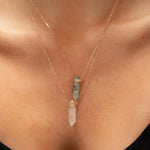 Close-up of a décolletage wearing two Retreat Necklaces in Protection and Clarity. 