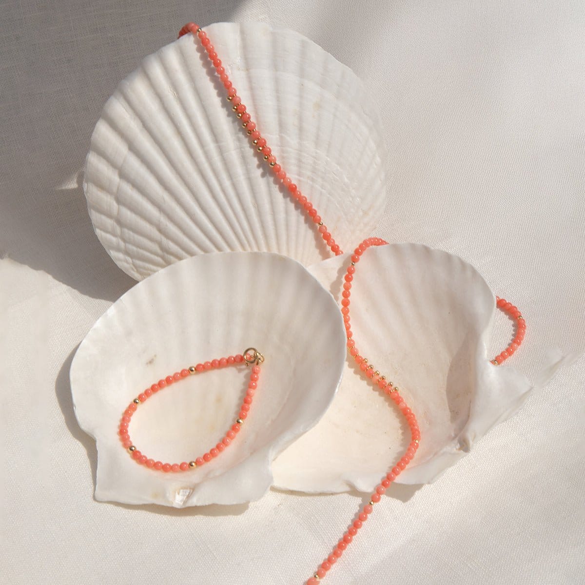An Endless Summer Bracelet and Necklace in Mykonos laid on white seashells. 
