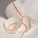 An Endless Summer Bracelet and Necklace in Mykonos laid on white seashells. 
