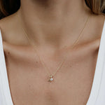 A woman's decellotage wearing a yellow gold Signature Cable Chain with a Gold Letter Jumble - A. 