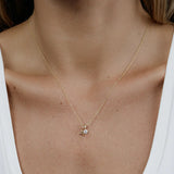 A woman's decellotage wearing a yellow gold Signature Cable Chain with a Gold Letter Jumble - A. 