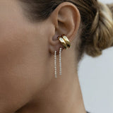 Close-up of an ear wearing two Down the Line Earrings and two yellow gold Ready to Mingle Ear Cuffs. 