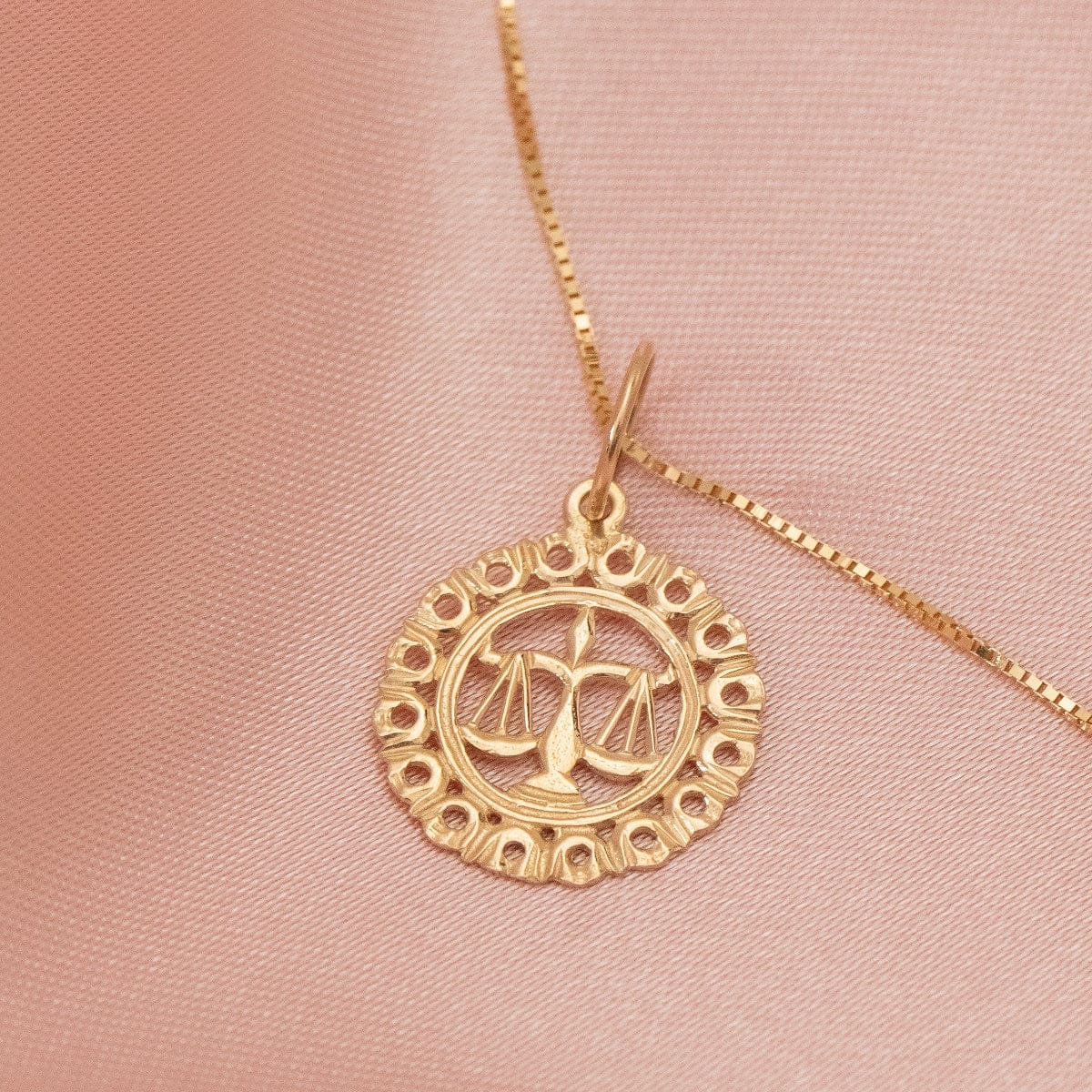 The Zodiac Necklace - Libra on a peach silk background. 