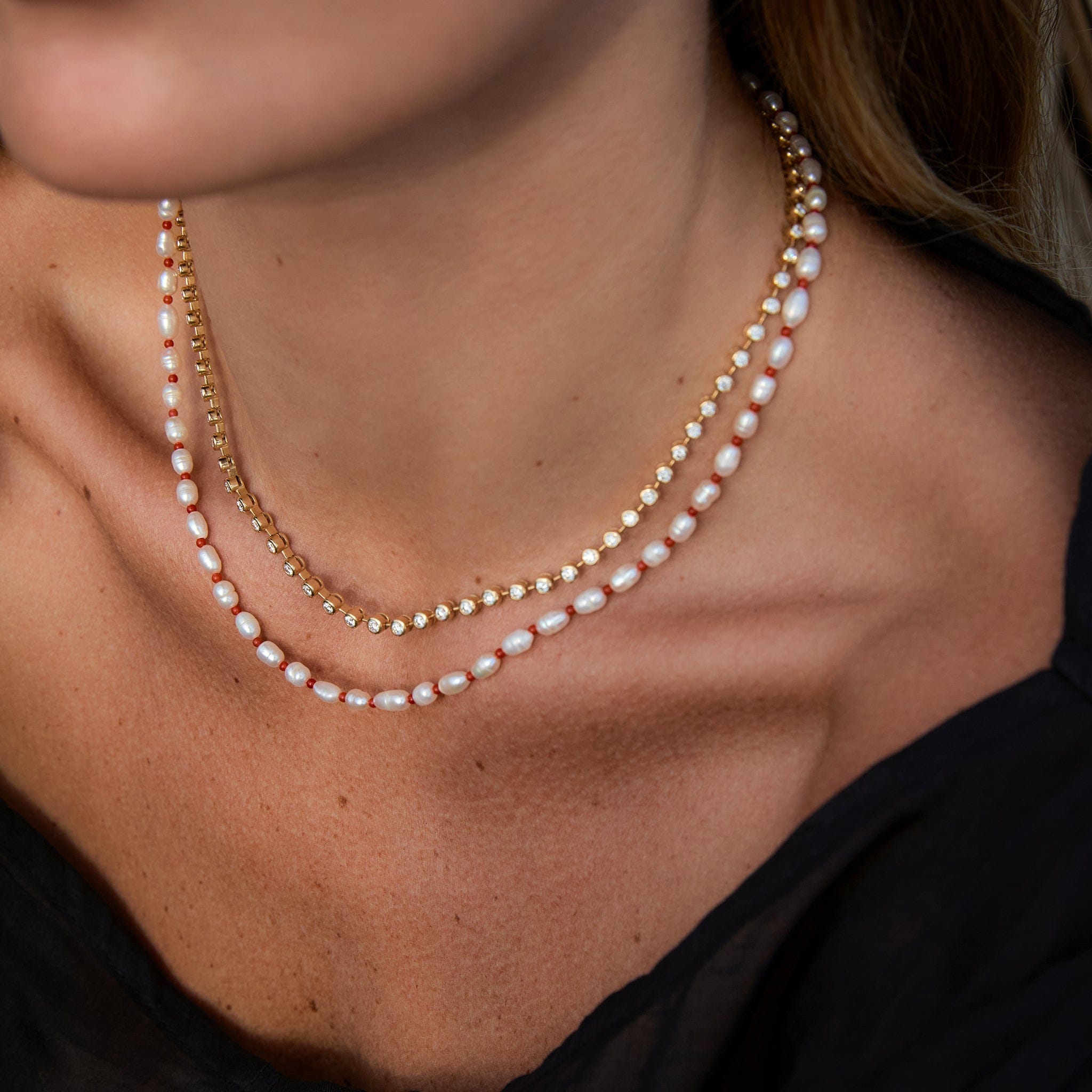 Close-up of Maya Brenner Cabana Pearl Necklace layered with the Ultimate Diamond Necklace on model