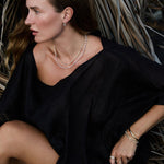 Model wearing Maya Brenner Cabana Pearl Necklace layered with the Ultimate Diamond Necklace, styled with gold rings, pearl bracelet, and gold cuff