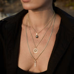 Model wearing the Nautical Rope Chain with the Find Your Way Pendant in a layered gold necklace look.