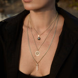 Model wearing the Nautical Rope Chain with the Find Your Way Pendant in a layered gold necklace look.