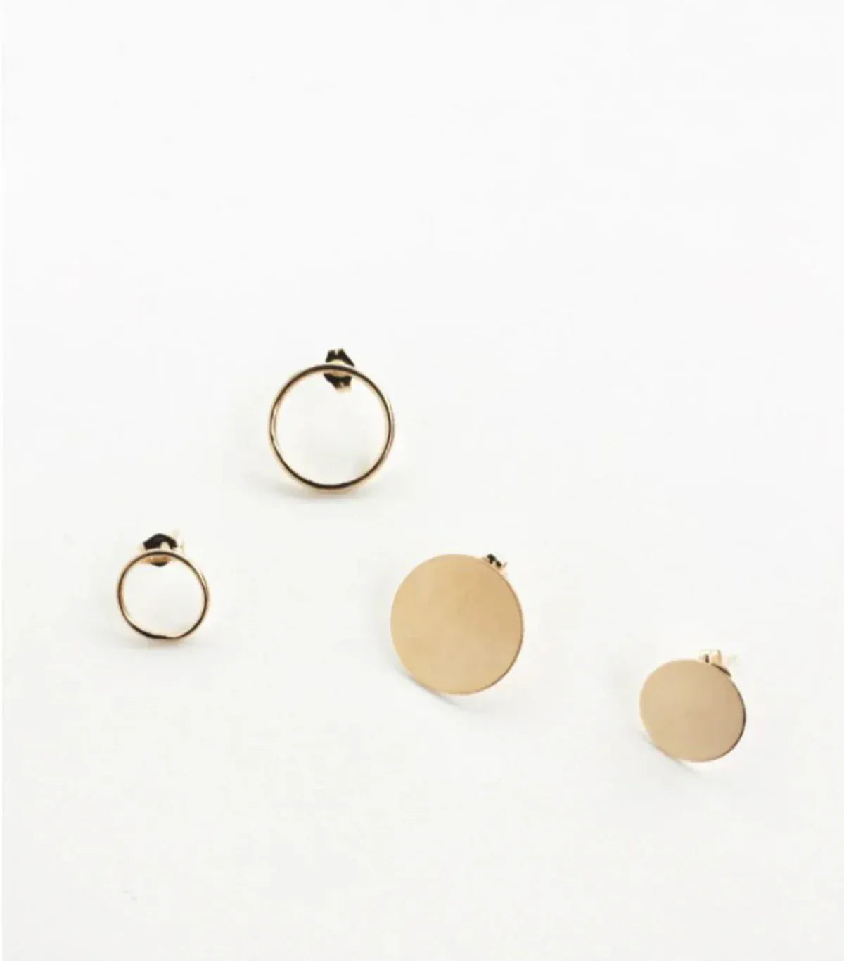 Two Open Eclipse Earrings (one small and one large) and two Solid Eclipse Earrings (one small and one large), all in yellow gold, on a white background.
