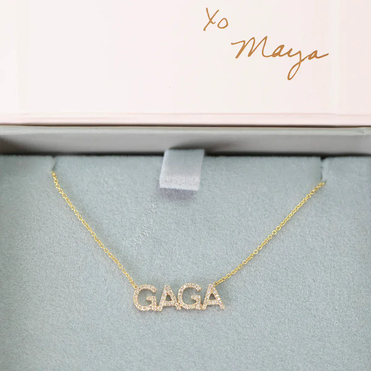 A Pavé GAGA Necklace in yellow gold with a cable chain in a Maya Brenner light grey and pink jewellery box. 