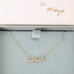 A Pavé GAGA Necklace in yellow gold with a cable chain in a Maya Brenner light grey and pink jewellery box. 