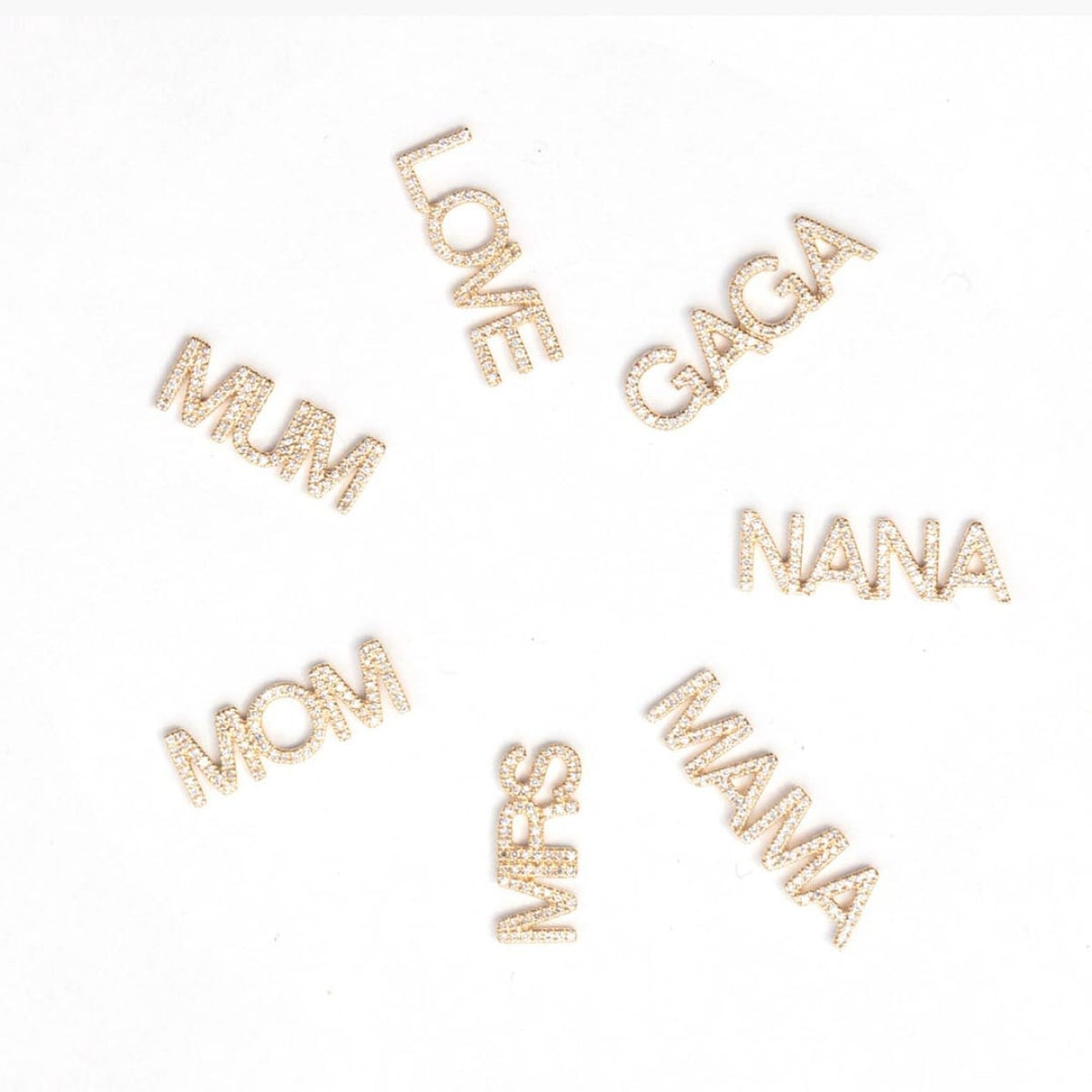 Pavé pendants MUM, LOVE, GAGA, NANA, MAMA, MRS and MOM on a white background. 
