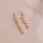 vertical small letter nameplates in lowercase letters 'sophia theordore'