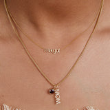 Gold necklace with 'margot' pendant on a person's neck