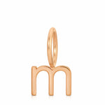 Rose gold letter 'm' pendant on a white background