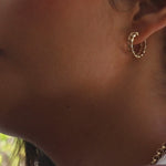 A video of a woman wearing a Link Hoop and Rolo Necklace. 
