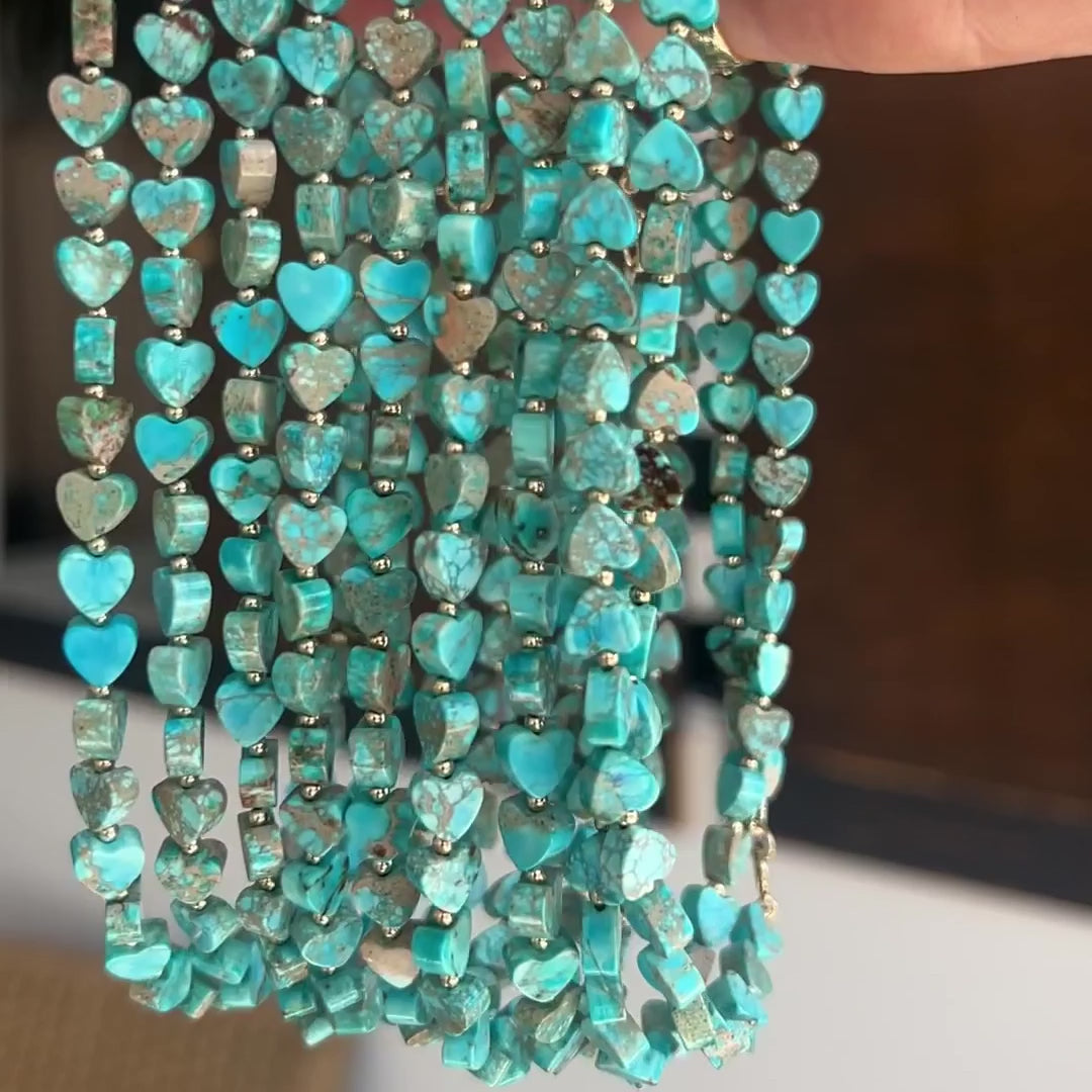 A video of a hand holding several Endless Summer Necklaces - Sea + Sky. 